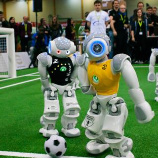 Two robots are fighting for the ball